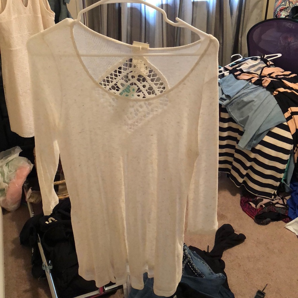 White long sleeved shirt with design on the back.